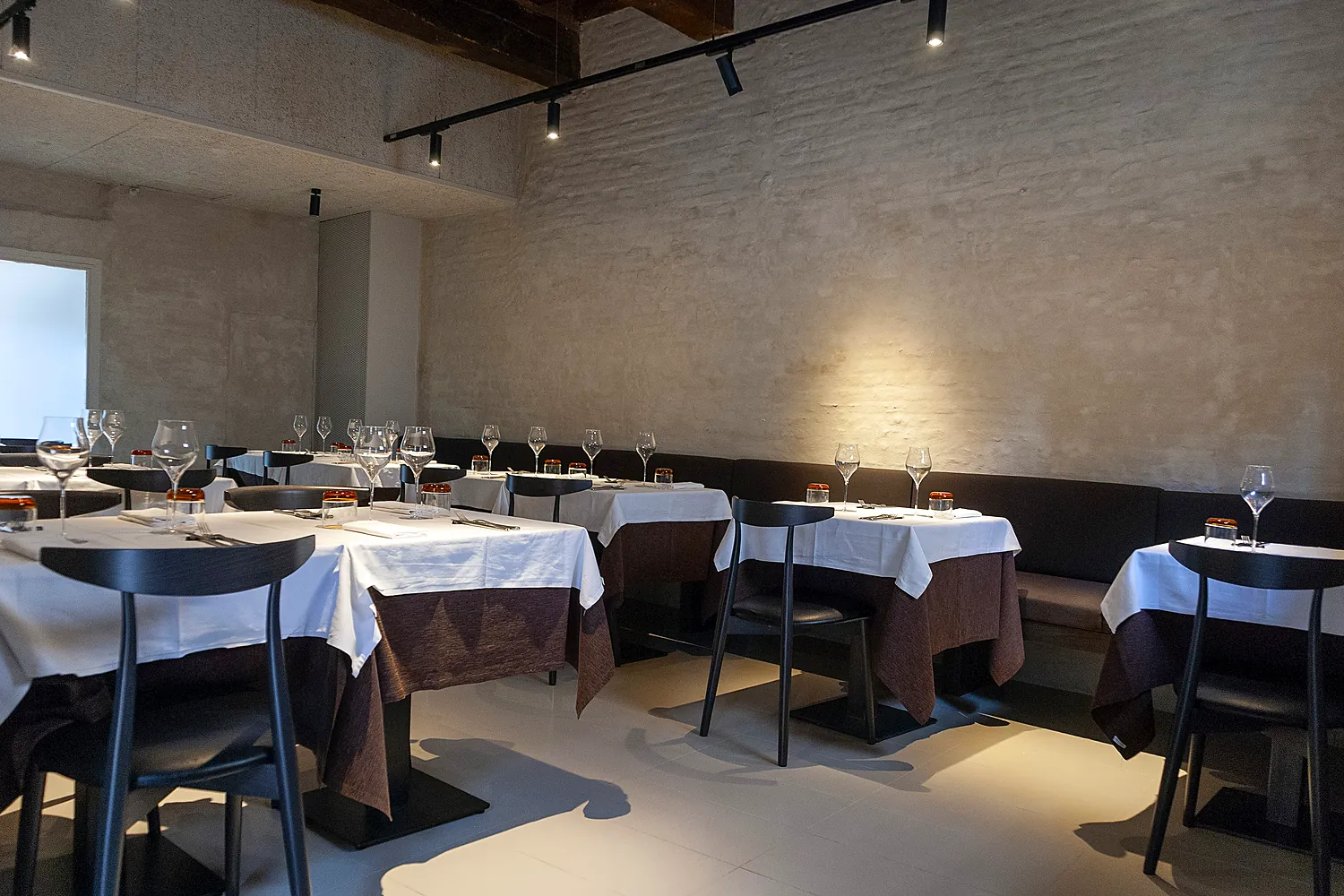 Sala da pranzo di Tao a Modena: tavoli, pietra antica e travi a vista